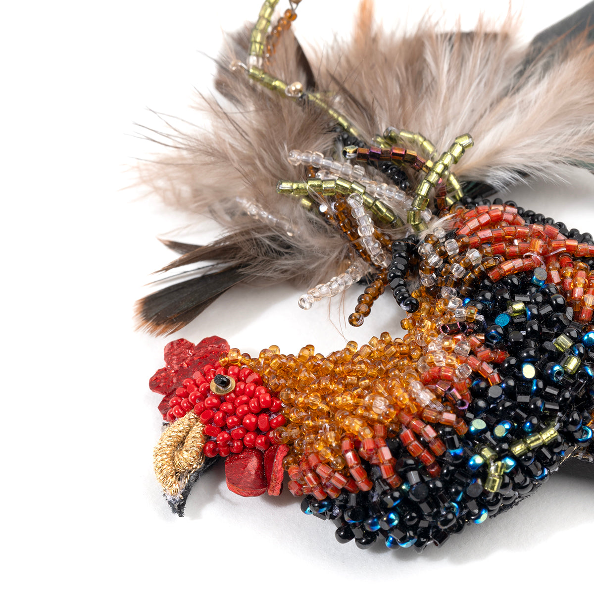 Detail of Deepa Gurnani handmade Rooster brooch in rust color