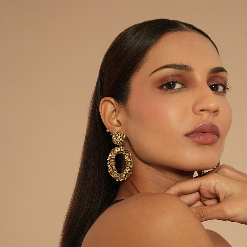 Model wearing Deepa Gurnani Dinorah Earrings in Gold color