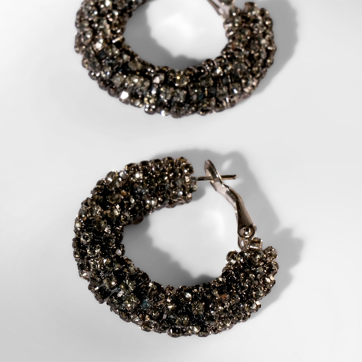 Close up of Deepa Gurnani Sousou Earrings in gunmetal color