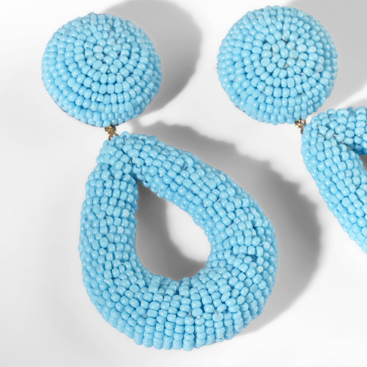 Close up of Deepa Gurnani Maura Earrings in turquoise color