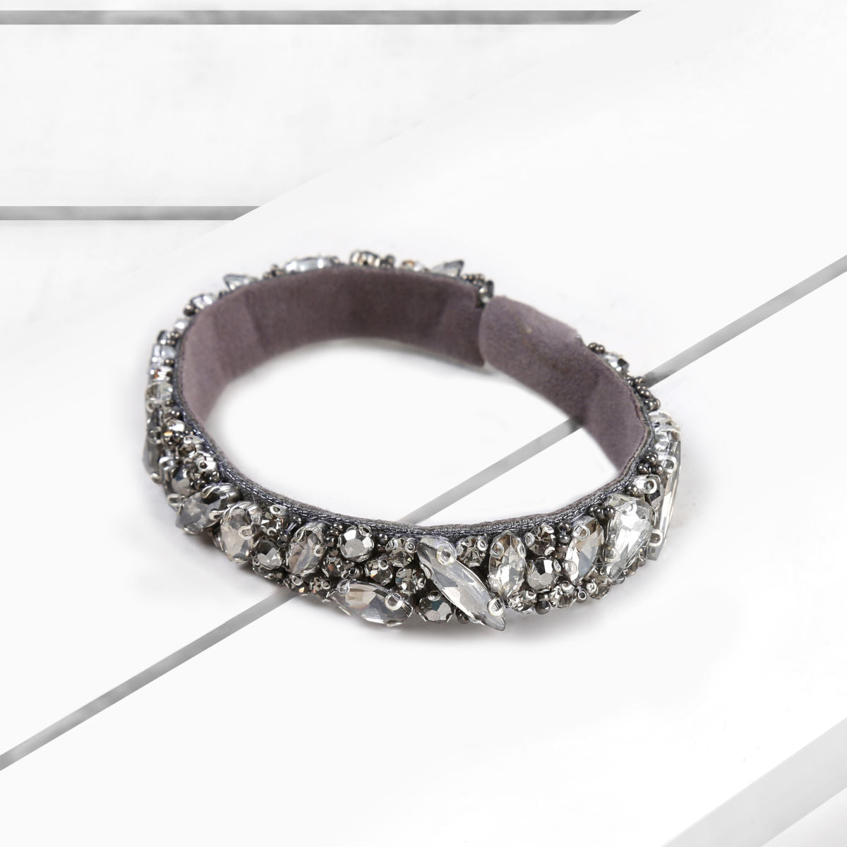 Deepa by Deepa Gurnani Handmade Avalon Cuff Gun on Wood Background