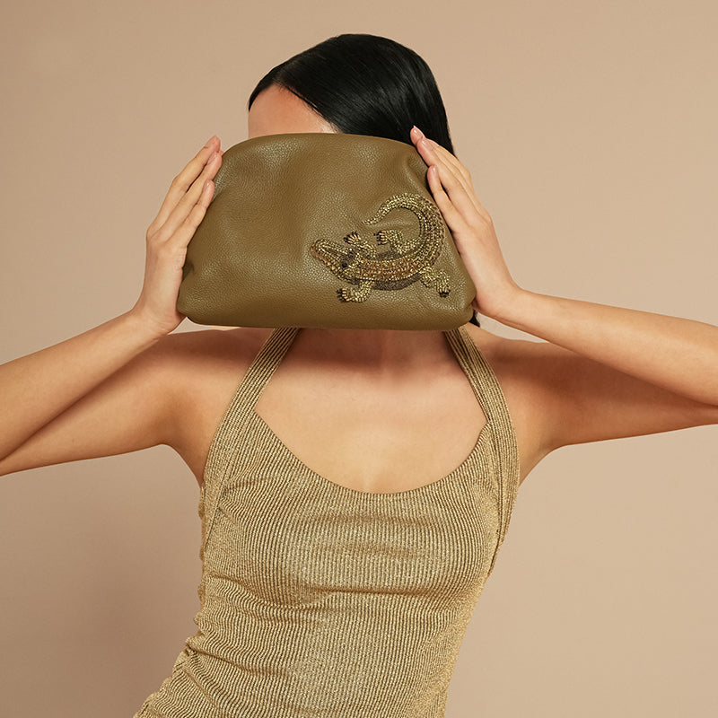 Model holding Deepa Gurnani Alligator Clutch 