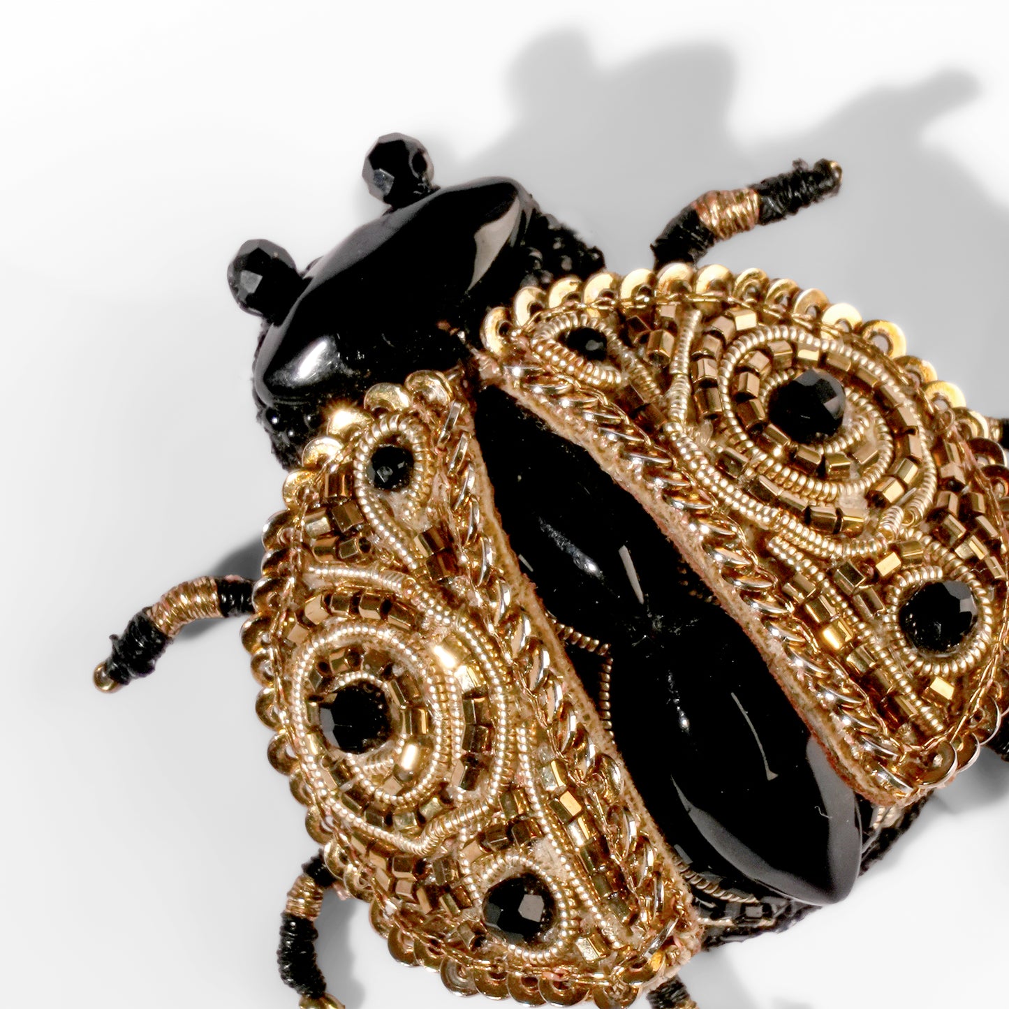 Close up of Deepa Gurnani Ladybug brooch 