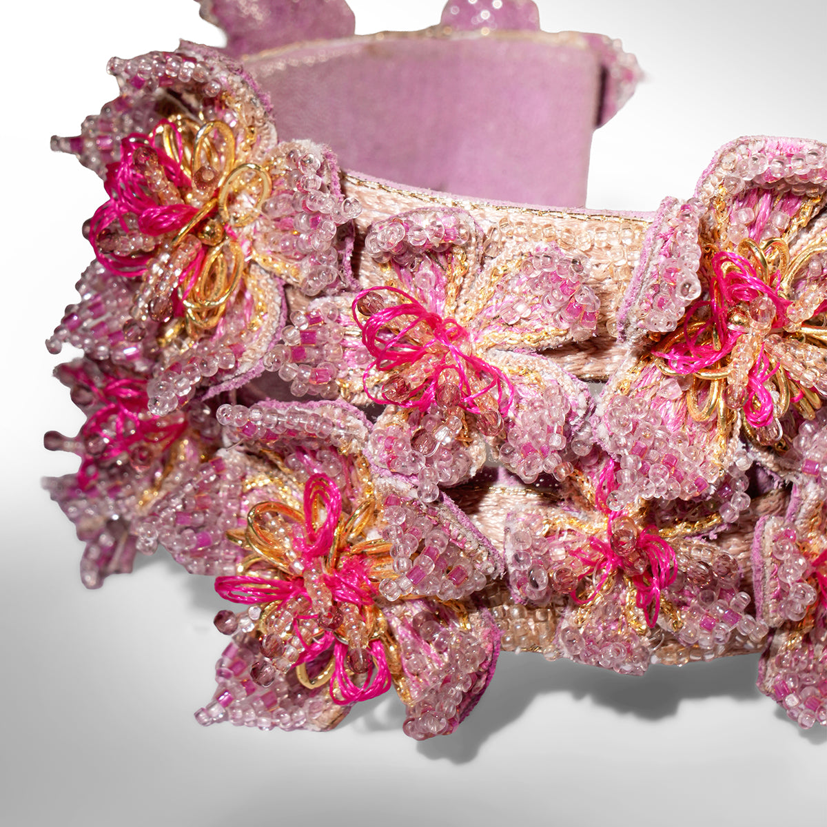 Close up of Deepa Gurnani Adva Cuff in fuchsia color