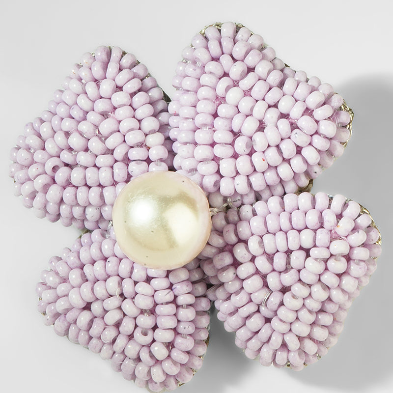 Pink beaded flower with a pearl center on a white background