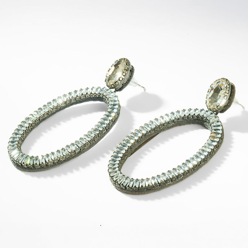 Pair of silver hoop earrings with gemstone accents on a white background