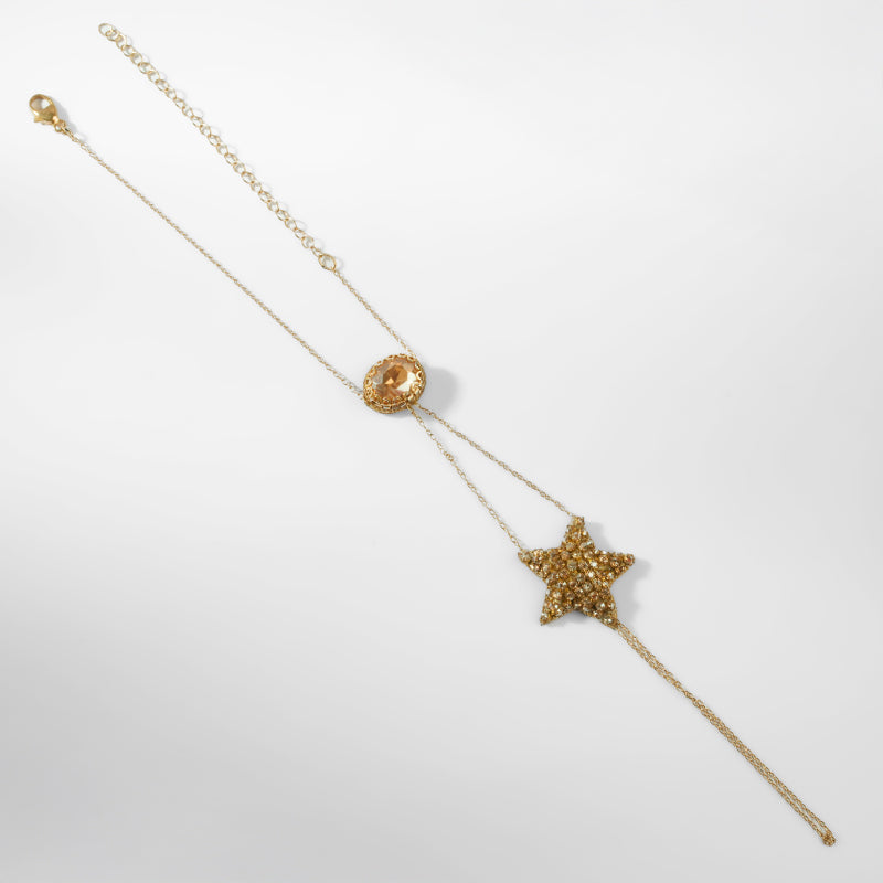 Gold star-shaped hand chain on a white background