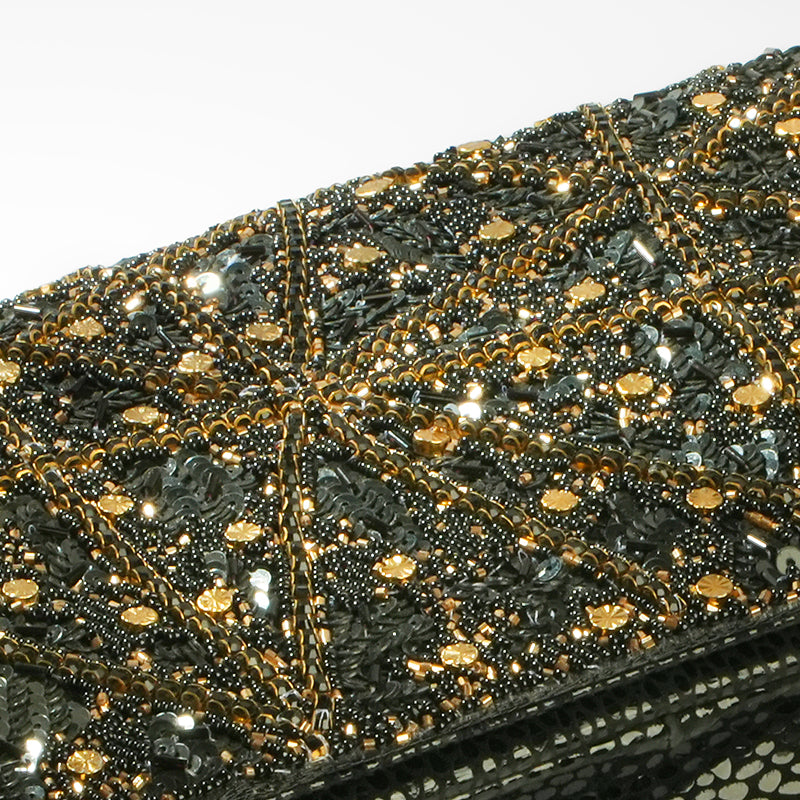 Close-up of a black and gold beaded clutch bag