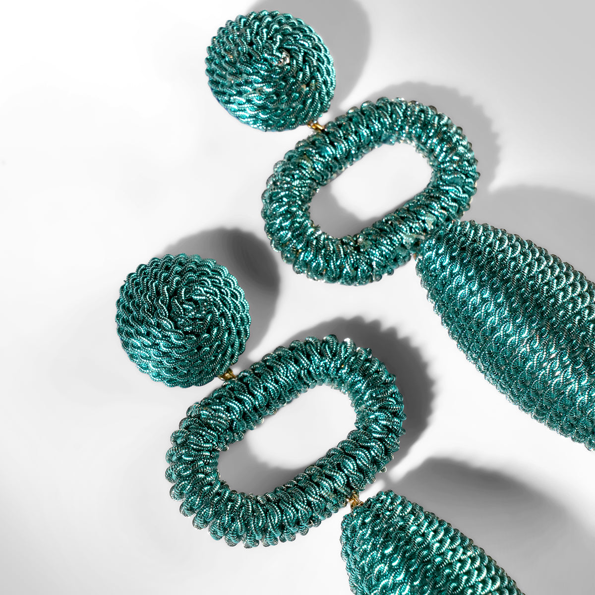 Close up of Deepa Gurnani Pret Fontanta Earrings in turquoise color