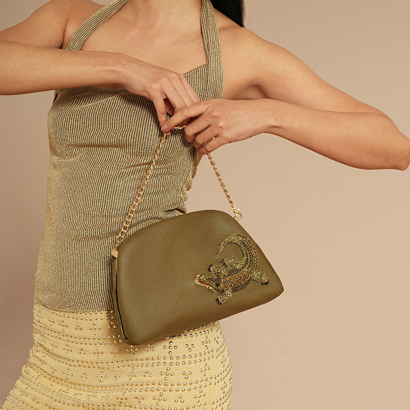 Model holding Deepa Gurnani Alligator Clutch 