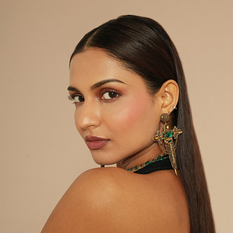 Model wearing Deepa Gurnani Dagger Earrings in Gold color
