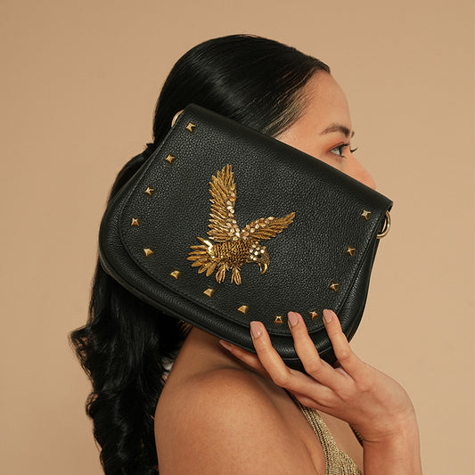 Model holding Deepa Gurnani Eagle handbag in Black color