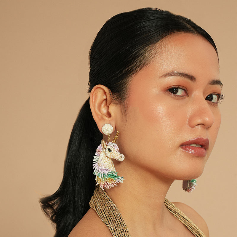 Model wearing Deepa Gurnani Unicorn earrings 