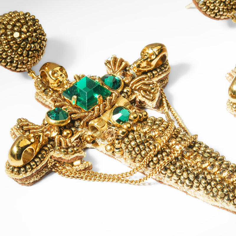 Close up of Deepa Gurnani Dagger Earrings in Emerald color