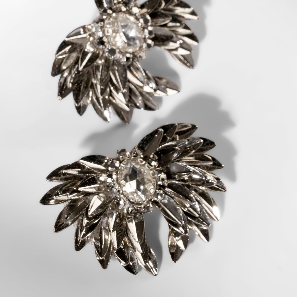 Close up of Deepa Gurnani Pret Ottie Earrings in gunmetal color