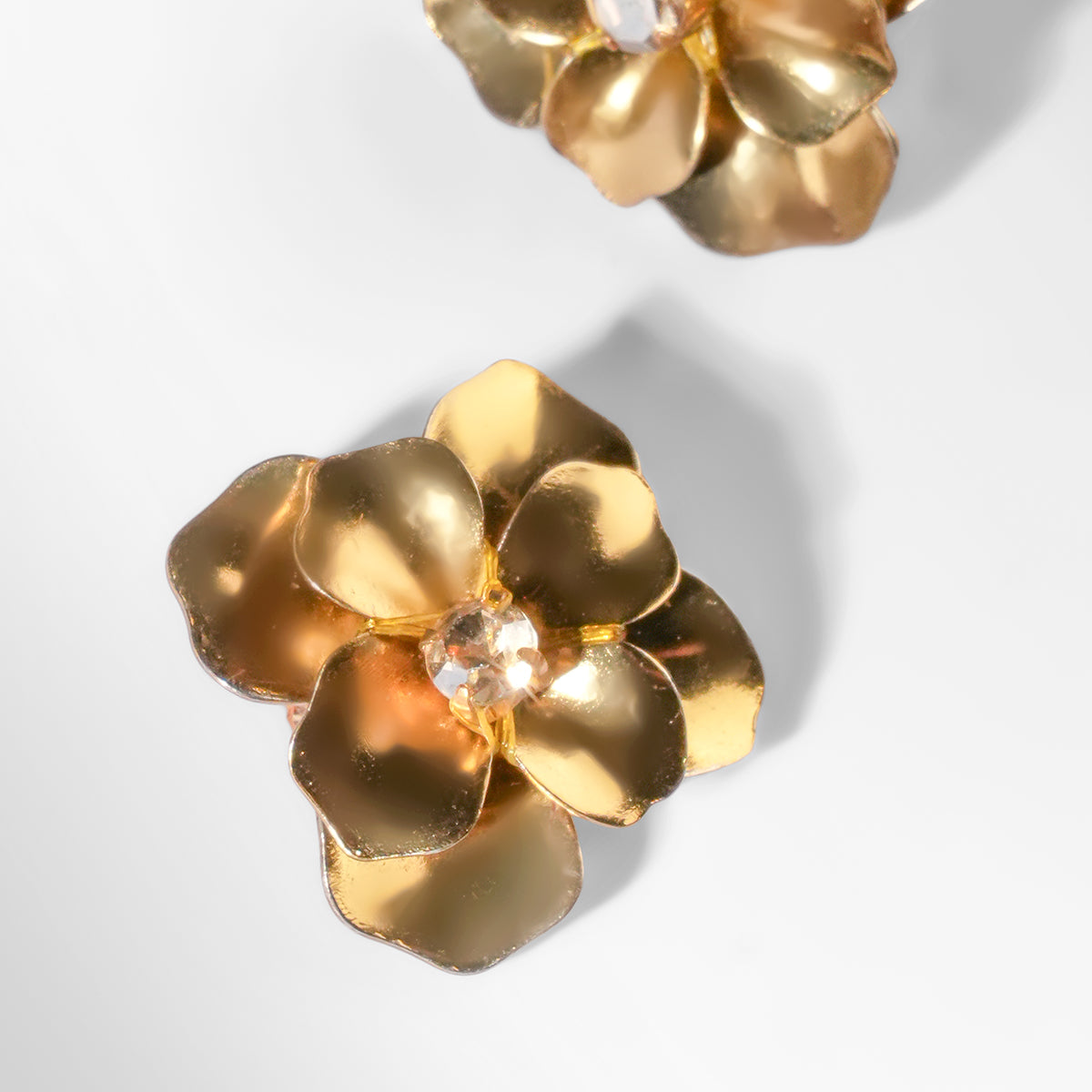 Close up of Deepa Gurnani Pret Siran Earrings in gold color