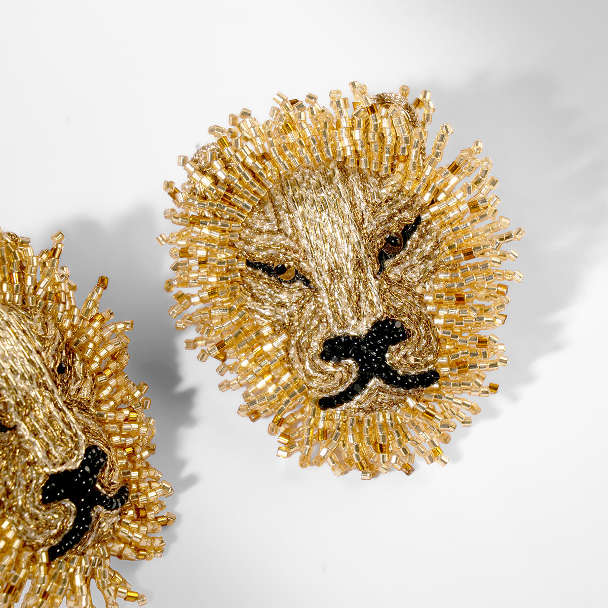Close up of Deepa Gurnani Mini Lion earrings