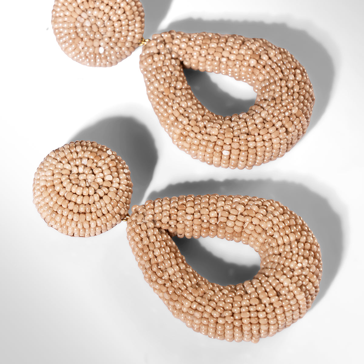 Close up of Deepa Gurnani Maura Earrings in champagne color