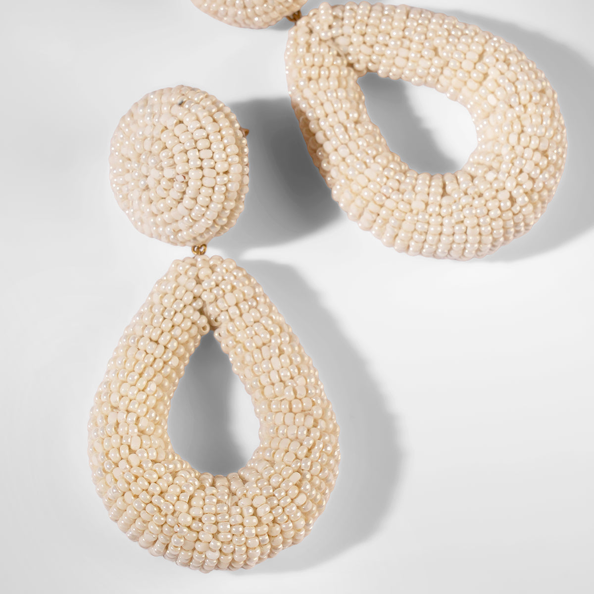 Close up of Deepa Gurnani Maura Earrings in ivory color 