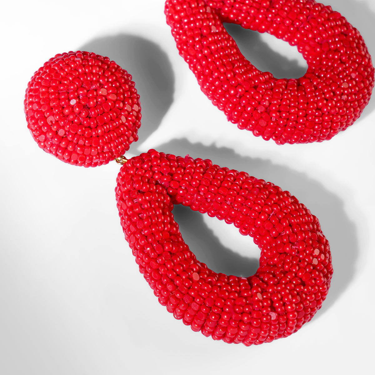 Close up of Deepa Gurnani Maura Earrings in red color