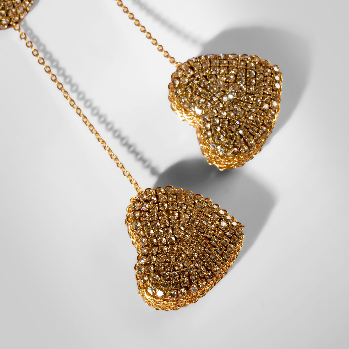 Close up of Deepa Gurnani Eros Earrings in gold color