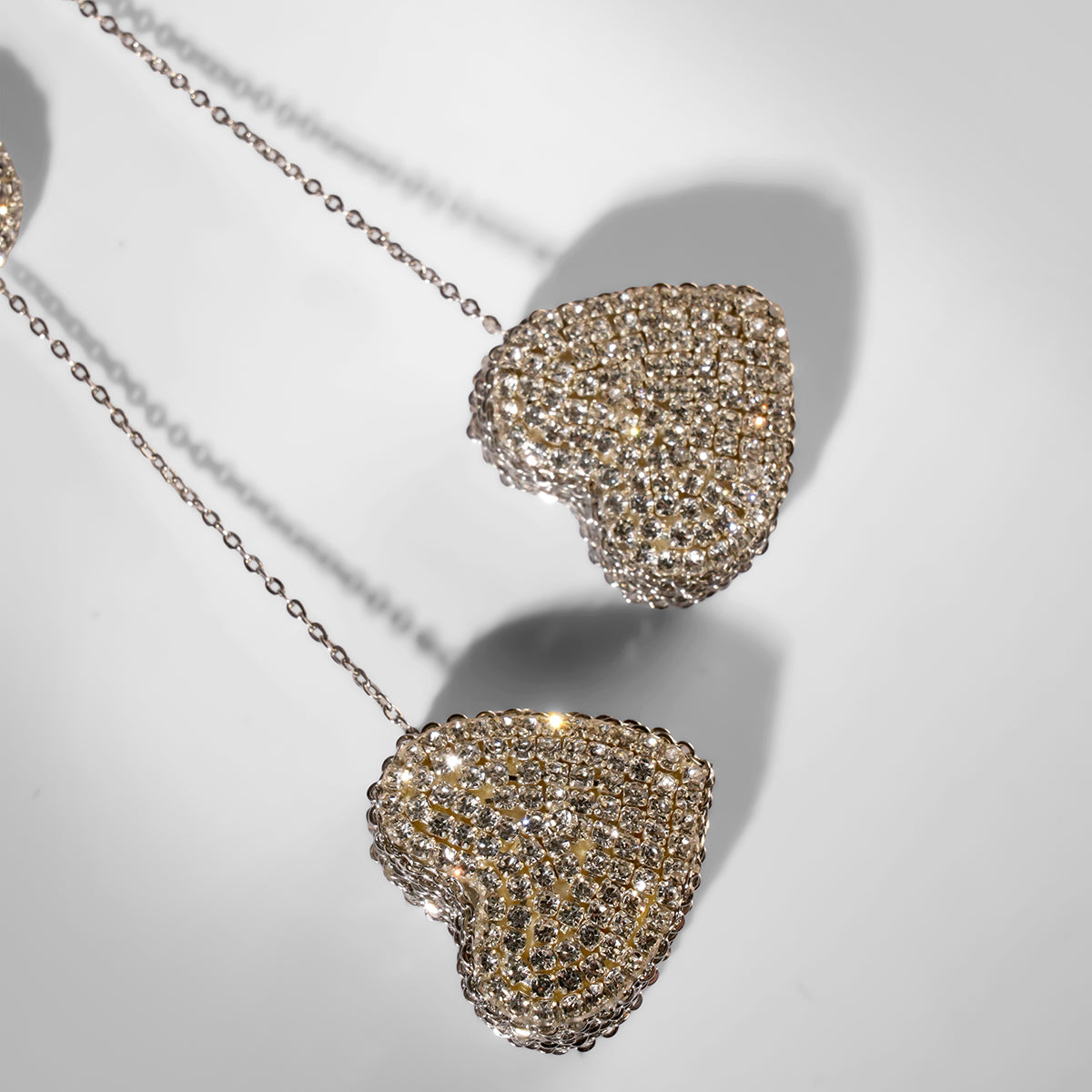 Close up of Deepa Gurnani Eros Earrings in silver color